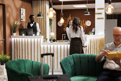 Rear view of woman sitting at restaurant