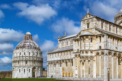 Pisa baptistry and cathedral stand on piazza dei miracoli in pisa, italy