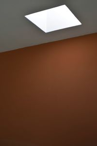 Low angle view of illuminated lamp at home