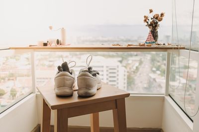 Rear view of woman sitting on chair at home