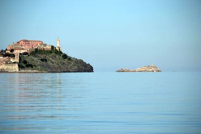 Island of elba by sea against clear sky