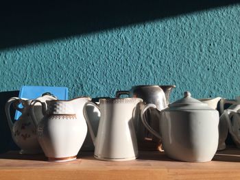 Close-up of various teapots on table