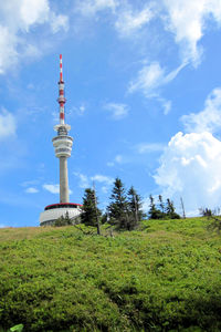 Low angle view of tower against cloudy sky