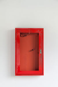 Close-up of red mailbox on wall