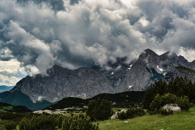 Scenic view of mountains against cloudy sky