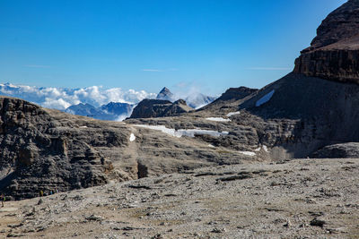 Scenic view of mountains against blue sky