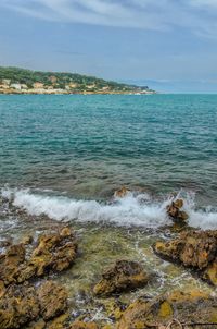 Scenic view of sea against cloudy sky