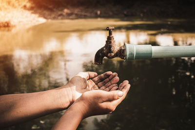 Cropped hand of people holding water