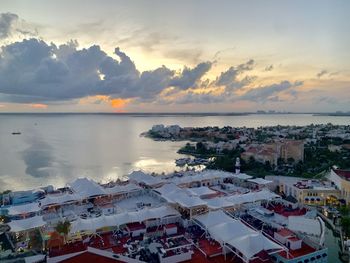 High angle view of townscape by sea against sky