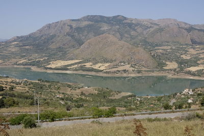 Scenic view of lake and mountains against clear sky