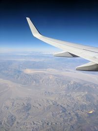 Aerial view of airplane wing over landscape