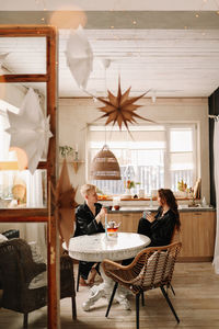 A couple in love have breakfast and drink tea in a decorated eco-style kitchen in a country house