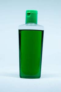 Close-up of green bottle against white background