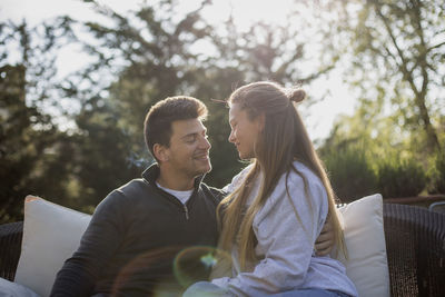 Smiling couple sitting in yard