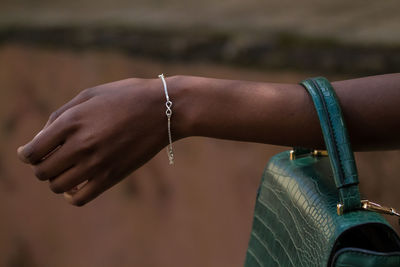 Close-up of woman hand with a sterling silver bracelet on her wrist.