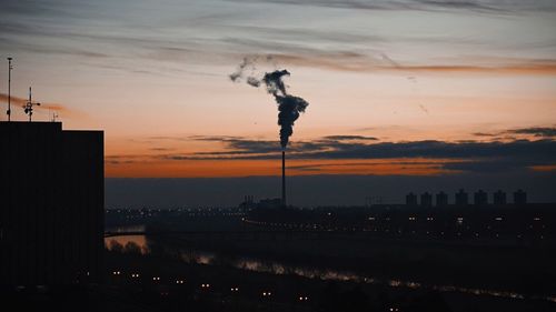 Smoke emitting from chimney against sky