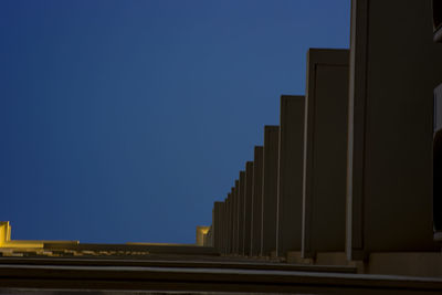 Low angle view of building against clear blue sky