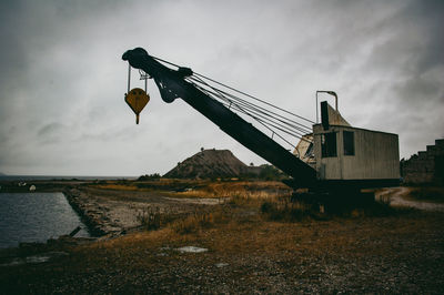 Windmill on field against sky