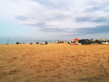 Scenic view of beach against cloudy sky