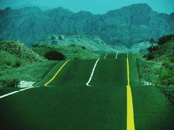 Country road leading towards mountains