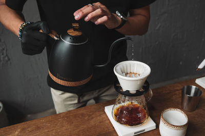 Barista dripping coffee and slow coffee wooden bar style