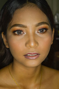Close-up portrait of young woman with make-up