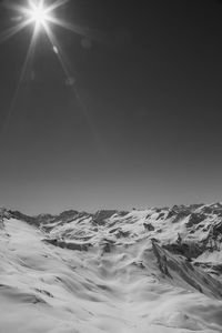 Scenic view of snowcapped mountains against clear sky