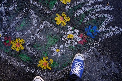 Low section of man standing on road