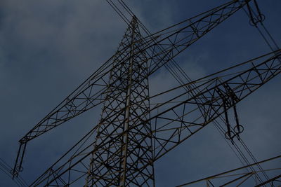 Low angle view of electricity pylon against sky