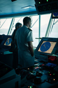 Rear view of people traveling in boat