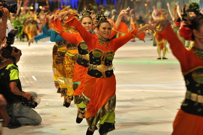 Smiling artists performing traditional dance during carnival