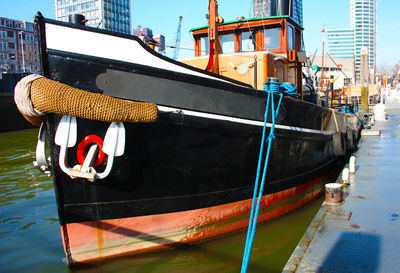 Boat moored on harbor in city
