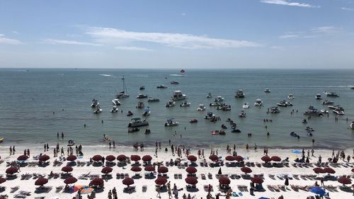 Group of people on beach against sky