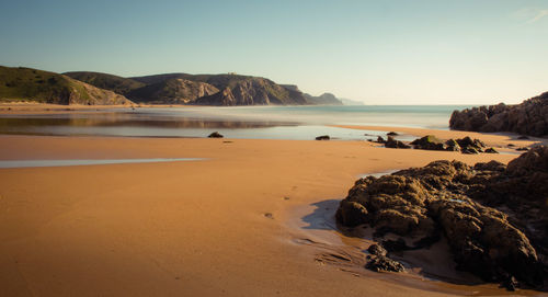 Scenic view of beach against clear sky