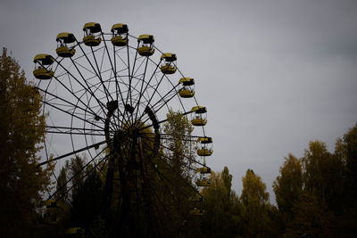 Low angle view of ferris wheel against sky