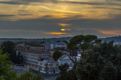 High angle shot of townscape against sky at sunset