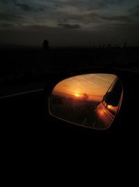 Reflection of sky in side-view mirror