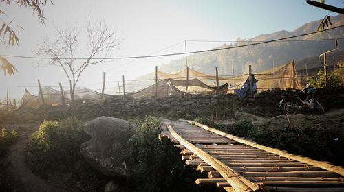 People on bridge against sky