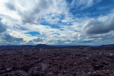 High angle view of city against cloudy sky