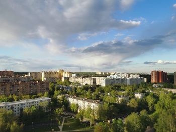 High angle view of trees and buildings against sky