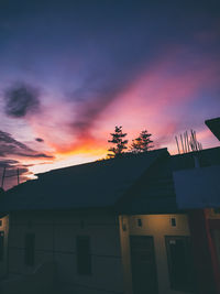 Low angle view of building against sky at sunset