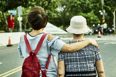 Rear view of women walking on street