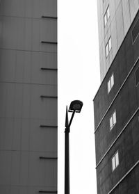 Low angle view of street light against building