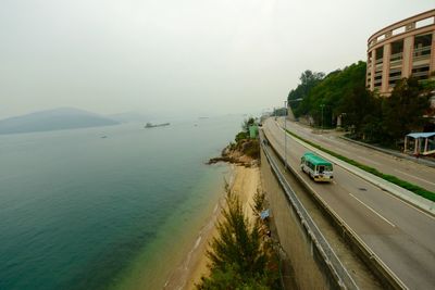 Panoramic view of cars on shore against sky