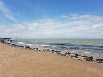 View of beach against cloudy sky