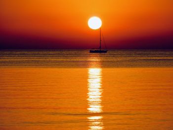 Scenic view of sea against orange sky