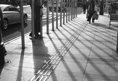 People walking on footpath in city