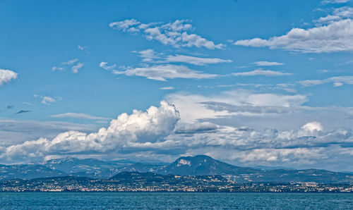 Scenic view of sea and mountains against sky