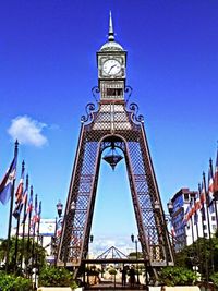 Low angle view of tower against blue sky