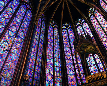 Low angle view of glass window of building sainte chapelle paris